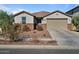 Single-story home with a two-car garage and nicely landscaped yard at 17838 W Gambit Trl, Surprise, AZ 85387