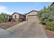 Single-story home with a two-car garage and nicely landscaped yard at 17838 W Gambit Trl, Surprise, AZ 85387