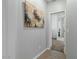 Light and bright hallway with wood-look tile flooring at 17838 W Gambit Trl, Surprise, AZ 85387