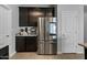 Stainless steel appliances and dark cabinetry feature in this kitchen at 17838 W Gambit Trl, Surprise, AZ 85387