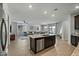 Open concept kitchen island with granite countertop and seating at 17838 W Gambit Trl, Surprise, AZ 85387