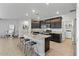 Open kitchen with granite countertops and stainless steel appliances at 17838 W Gambit Trl, Surprise, AZ 85387