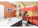 Bathroom with sunset shower curtain and dark vanity at 1840 S Vista Rd, Apache Junction, AZ 85119