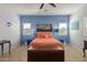 Spacious bedroom with orange bedding and tiled floors at 1840 S Vista Rd, Apache Junction, AZ 85119