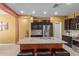 Island kitchen with granite countertops and dark wood cabinets at 1840 S Vista Rd, Apache Junction, AZ 85119