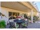 Covered patio features table and chairs, inviting for relaxation at 19608 N Papago Dr, Surprise, AZ 85374