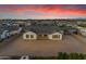 Aerial view of a house with a large backyard and a beautiful sunset sky at 19727 E Vallejo St, Queen Creek, AZ 85142