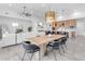 Bright dining area with a large wooden table and modern black chairs at 19727 E Vallejo St, Queen Creek, AZ 85142