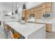 Modern kitchen island with white countertop and leather barstools at 19727 E Vallejo St, Queen Creek, AZ 85142