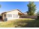 Tan house exterior with a covered patio and grassy yard at 2123 E Saratoga St, Gilbert, AZ 85296