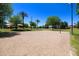 Community sand volleyball court with surrounding landscaping and palm trees at 2123 E Saratoga St, Gilbert, AZ 85296