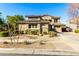 Two-story house with desert landscaping, a three-car garage, and solar panels at 21932 S 185Th Way, Queen Creek, AZ 85142