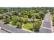 Aerial view of a well-maintained home featuring mature trees, a manicured lawn, and lush landscaping at 245 W Berridge Ln, Phoenix, AZ 85013