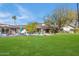 Large backyard with grassy lawn and patio area at 245 W Berridge Ln, Phoenix, AZ 85013