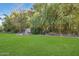 Landscaped backyard with lush lawn, bamboo, and stone seating area at 245 W Berridge Ln, Phoenix, AZ 85013