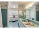 Retro bathroom with teal tile, built-in vanity, and large mirror at 245 W Berridge Ln, Phoenix, AZ 85013