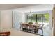 Dining room featuring a large wooden table, contemporary art, and backyard view at 245 W Berridge Ln, Phoenix, AZ 85013