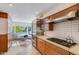 Modern kitchen with wood cabinets, stainless steel appliances, and terrazzo counters at 245 W Berridge Ln, Phoenix, AZ 85013