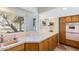 Kitchen features pink sink, terrazzo counters, and built-in oven at 245 W Berridge Ln, Phoenix, AZ 85013