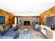 Charming living room with wood paneling, fireplace, and backyard view at 245 W Berridge Ln, Phoenix, AZ 85013