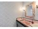 Pink powder room with patterned wallpaper and unique sink at 245 W Berridge Ln, Phoenix, AZ 85013