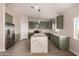 Modern kitchen with green cabinets and marble island at 2875 S 364Th Dr, Tonopah, AZ 85354