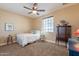 Charming bedroom with a metal bed frame and window at 42516 N Suburban Ave, San Tan Valley, AZ 85140