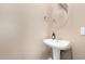 Simple pedestal sink and round mirror in a small bathroom at 4301 N 21St St # 24, Phoenix, AZ 85016