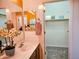 Bathroom featuring a single sink vanity, mirror, and doorway to a walk-in closet at 5028 S Peachwood Dr, Gilbert, AZ 85298