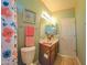 Cozy bathroom with decorative wallpaper border, floral shower curtain, and a tiled floor at 5028 S Peachwood Dr, Gilbert, AZ 85298