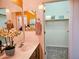 Bright bathroom featuring a single sink vanity and open closet space for optimal storage at 5028 S Peachwood Dr, Gilbert, AZ 85298