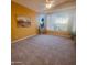 Bedroom with neutral walls, plush carpet, ceiling fan, and large windows offering ample natural light at 5028 S Peachwood Dr, Gilbert, AZ 85298