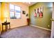Bedroom with a large picture window, ceiling fan, and neutral colored carpet at 5028 S Peachwood Dr, Gilbert, AZ 85298