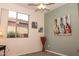 Bedroom featuring soft carpet, colorful wall art, and bright light from the window at 5028 S Peachwood Dr, Gilbert, AZ 85298