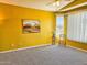 Spacious bedroom with a ceiling fan, neutral carpet, and a large bay window at 5028 S Peachwood Dr, Gilbert, AZ 85298