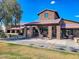 Exterior view of the community clubhouse with stone accents and outdoor seating area for relaxing at 5028 S Peachwood Dr, Gilbert, AZ 85298