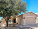 Charming single-story home featuring a well-manicured front yard with mature tree and covered porch at 5028 S Peachwood Dr, Gilbert, AZ 85298