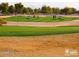 Golf course with players and golf carts at 5028 S Peachwood Dr, Gilbert, AZ 85298