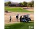 Golf course with players and golf carts at 5028 S Peachwood Dr, Gilbert, AZ 85298
