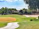 Well-maintained golf course with paved cart path winding through lush green grass and mature trees, creating a serene setting at 5028 S Peachwood Dr, Gilbert, AZ 85298