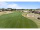 Scenic golf course view with lush green fairway, sand traps, and tranquil lake, blending recreation with natural beauty at 5028 S Peachwood Dr, Gilbert, AZ 85298