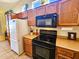 Kitchen features dark wood cabinets, an island, and modern appliances at 5028 S Peachwood Dr, Gilbert, AZ 85298