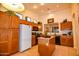 Traditional eat-in kitchen featuring tile floors, wooden cabinets, an island, and modern appliances at 5028 S Peachwood Dr, Gilbert, AZ 85298