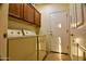 Bright laundry room with washer, dryer, and cabinets at 5028 S Peachwood Dr, Gilbert, AZ 85298