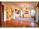 Open floorplan living room featuring hardwood and carpet floors, a ceiling fan, and neutral colors at 5028 S Peachwood Dr, Gilbert, AZ 85298