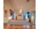 Spacious living room with plush carpet, ceiling fan, and natural light from large windows at 5028 S Peachwood Dr, Gilbert, AZ 85298