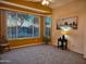 Bright living room featuring neutral carpet, bay windows, and modern decor at 5028 S Peachwood Dr, Gilbert, AZ 85298