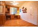 Bright office featuring hardwood floors, built-in shelves, and a large window at 5028 S Peachwood Dr, Gilbert, AZ 85298
