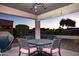 Evening view of covered patio with seating area at 5028 S Peachwood Dr, Gilbert, AZ 85298