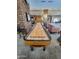Shuffleboard table in recreation room with comfortable seating and a stone accent wall at 5028 S Peachwood Dr, Gilbert, AZ 85298